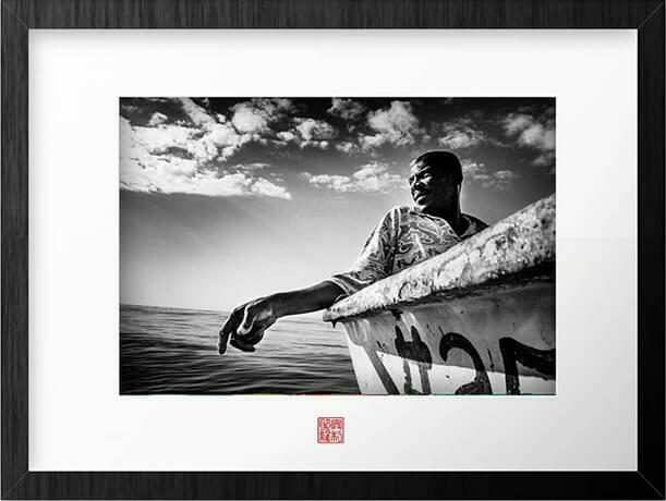 Framed black and white street photograph of a street performer