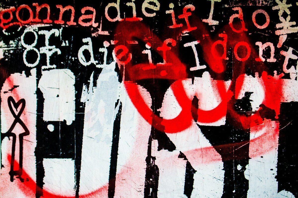Red and white graffiti lettering covering a wall
